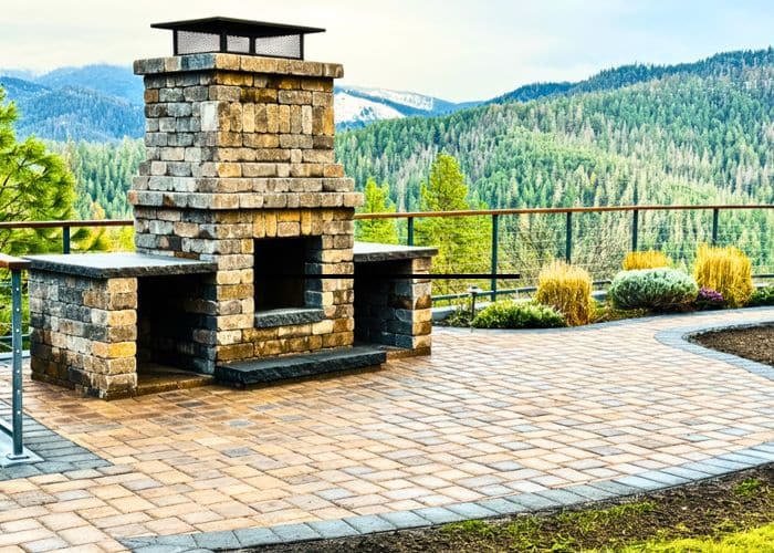 paver patio with a brick fire place